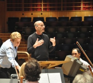 An undated photo of composer Richard Einhorn rehearsing a multimedia work for orchestra.