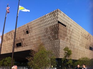 The facade of the museum glitters in the early morning sun. The exterior of the museum is modeled on West African Yoruban crowns, which have three tiers.